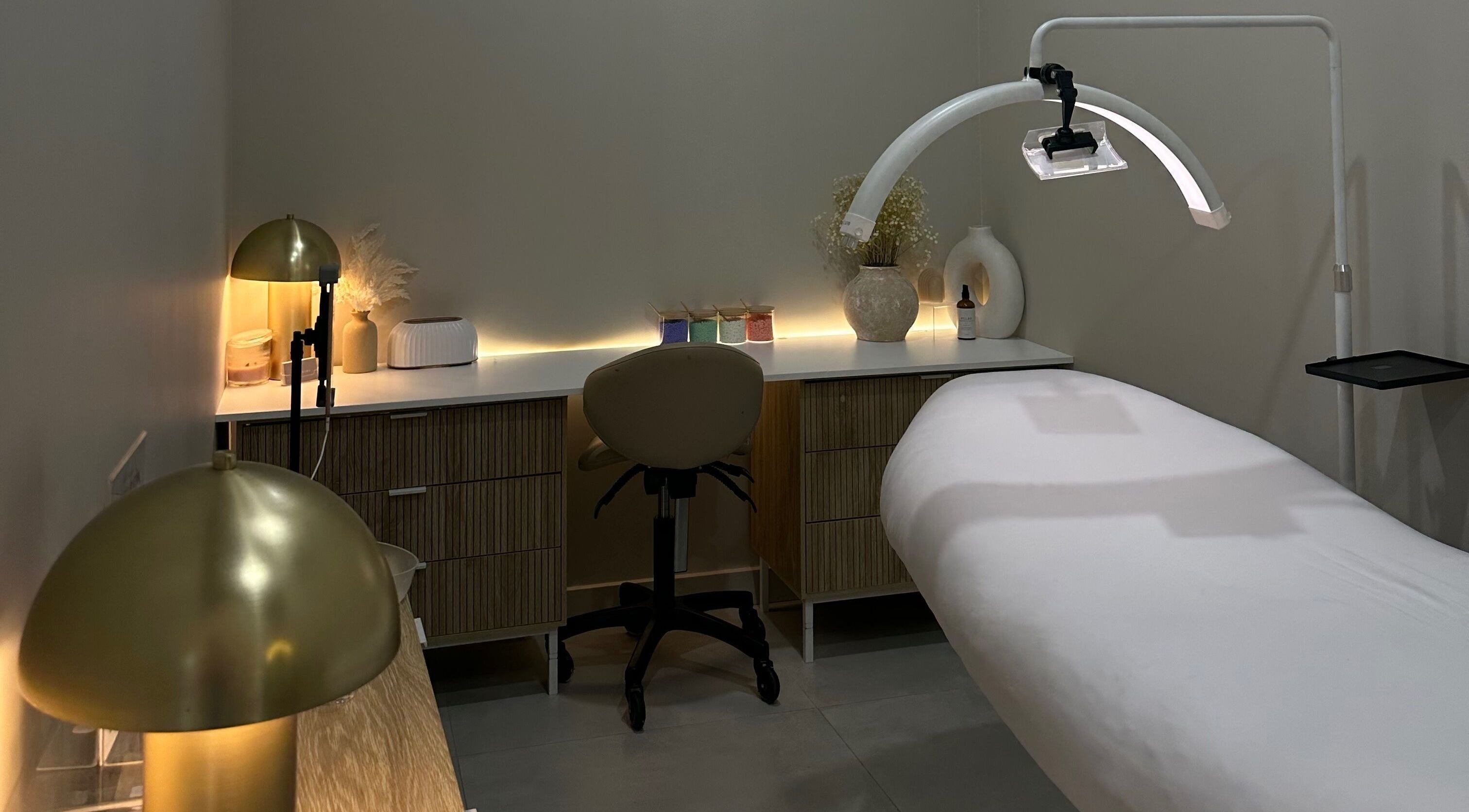 Peaceful treatment room at Arch & Aura, Greystanes, New South Wales, AU with warm lighting and modern decor.