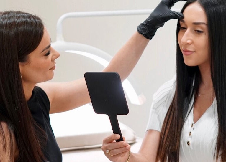 Beauty expert perfecting client's look at Arch & Aura, Greystanes, New South Wales, AU.