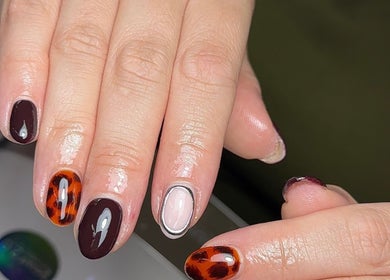 Stylish nail art design by HT Collective in Dronfield, England, GB featuring unique patterns and colors.