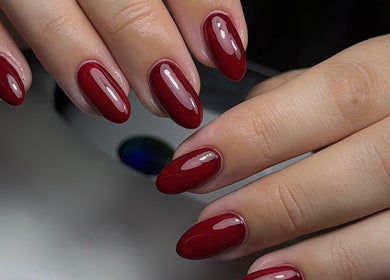 Red manicured nails at HT Collective, Dronfield, England, GB. Stunning finish for beauty and wellness seekers.