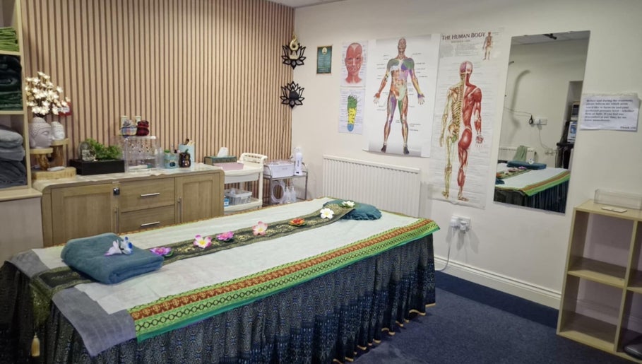 Massage room at U Sabai Massage & Spa, Newport, Wales, GB, featuring a decorated treatment bed.