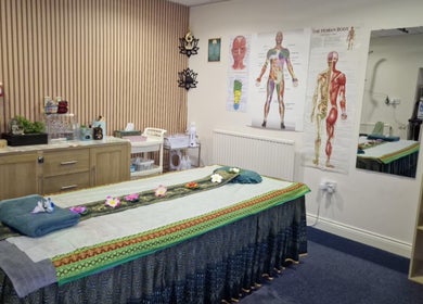 Massage room at U Sabai Massage & Spa, Newport, Wales, GB, featuring a decorated treatment bed.