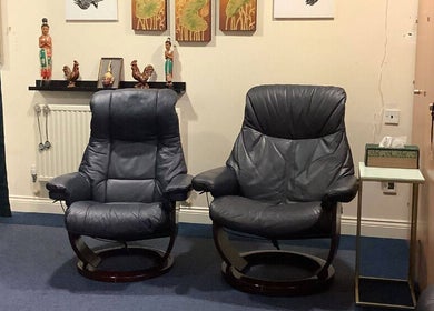 Relaxing seating area at U Sabai Massage & Spa, Newport, Wales, GB with cozy leather chairs.