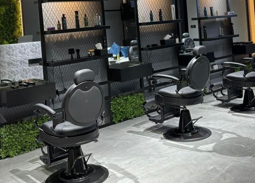 Interior view of Fade Oclock Barbershop in Dubai, Dubai, AE showcasing sleek barber chairs and stylish decor.