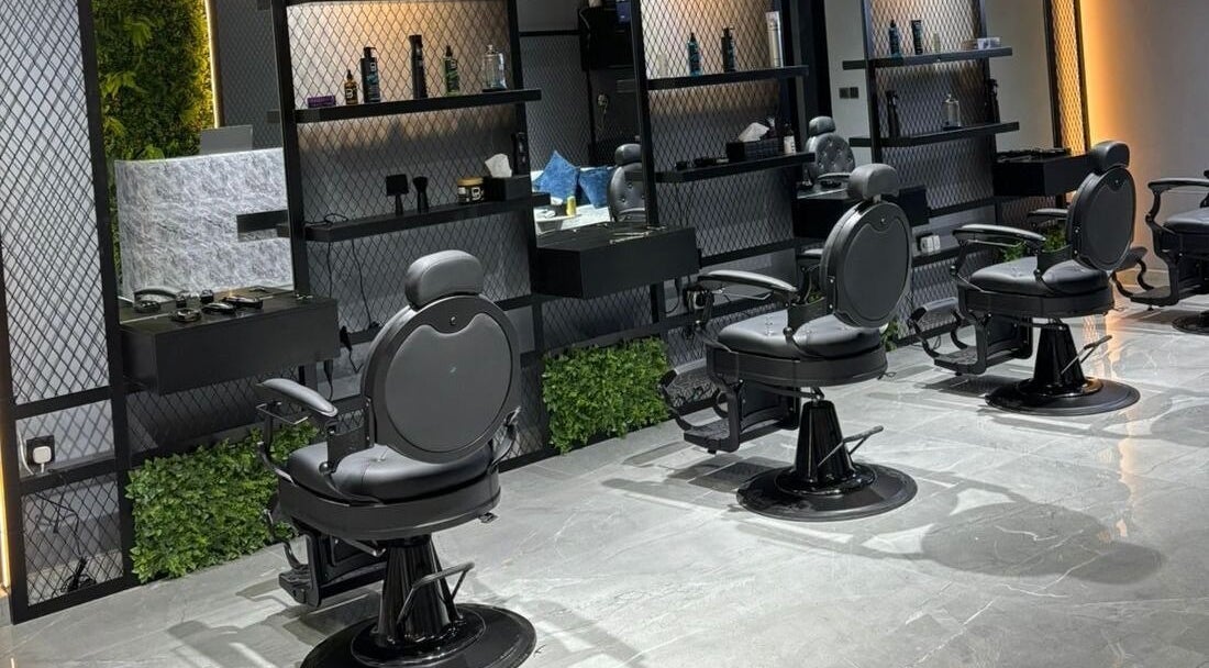 Interior view of Fade Oclock Barbershop in Dubai, Dubai, AE showcasing sleek barber chairs and stylish decor.