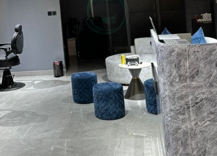 Elegant interior of Fade Oclock Barbershop in Dubai, Dubai, AE featuring stylish chairs and modern decor.