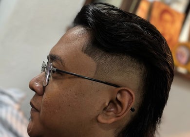 Modern hairstyle at Offcut Club, Singapore, SG showcasing sleek, undercut design.