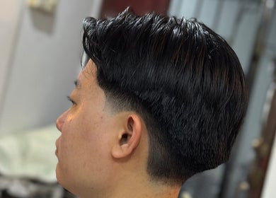 Man with a sleek haircut at Offcut Club, Singapore, SG showcasing stylish grooming.