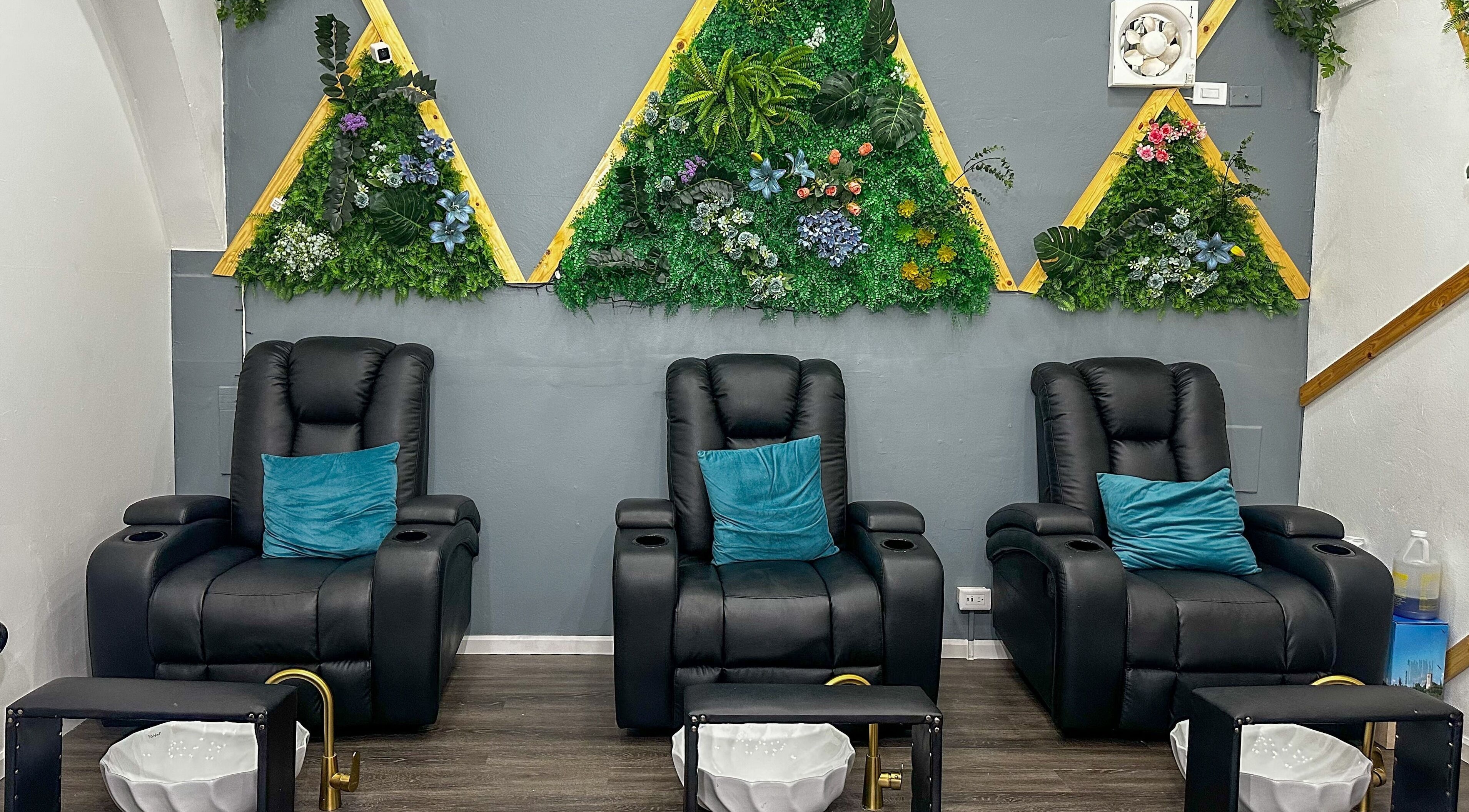 Luxurious seating at Vjm Beauty Salon, Port of Spain, with lush plant decor for a comforting experience.