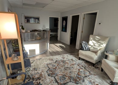 Inviting reception area of Naples Healing Arts in Naples, Florida, US, featuring comfortable seating and warm lighting.