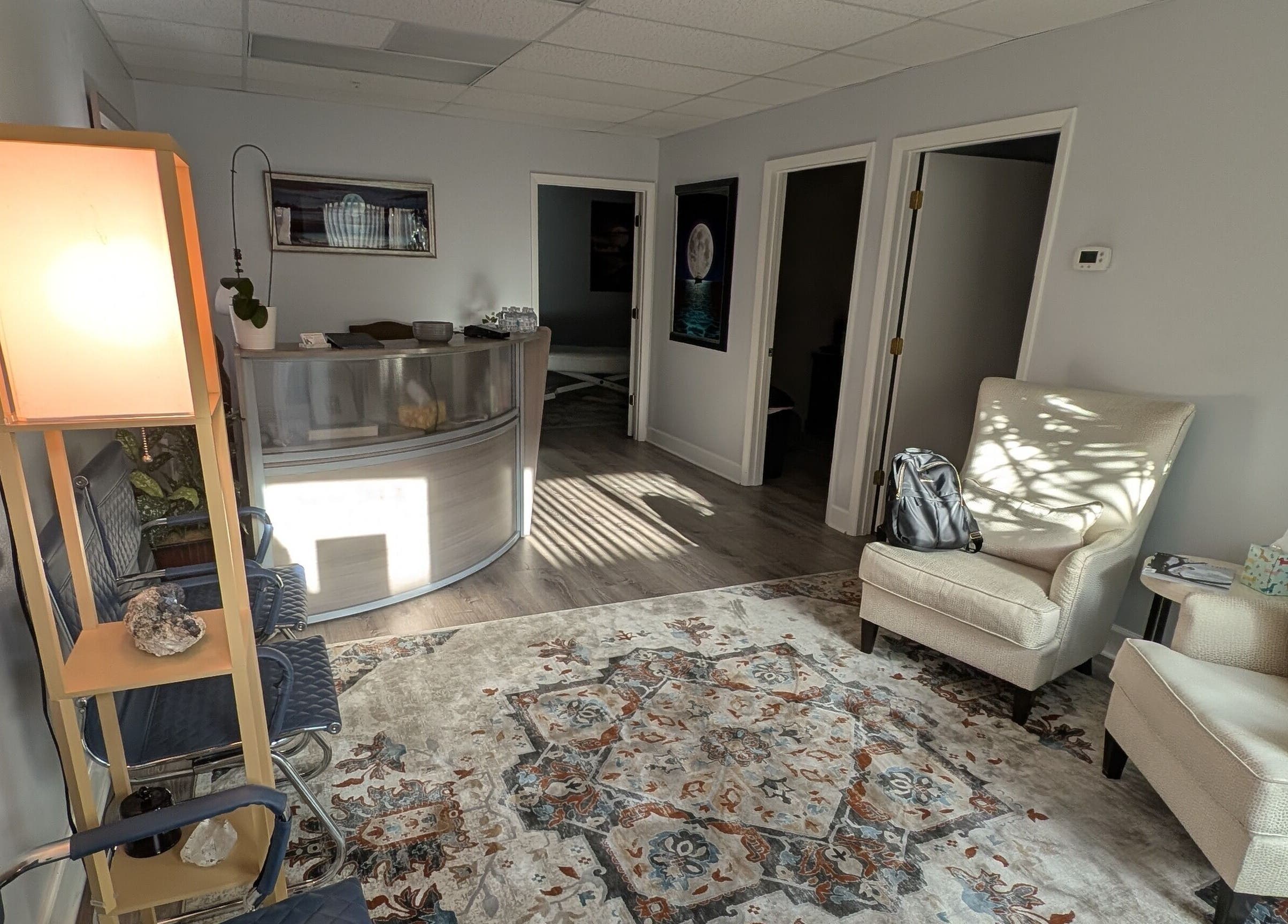 Inviting reception area of Naples Healing Arts in Naples, Florida, US, featuring comfortable seating and warm lighting.