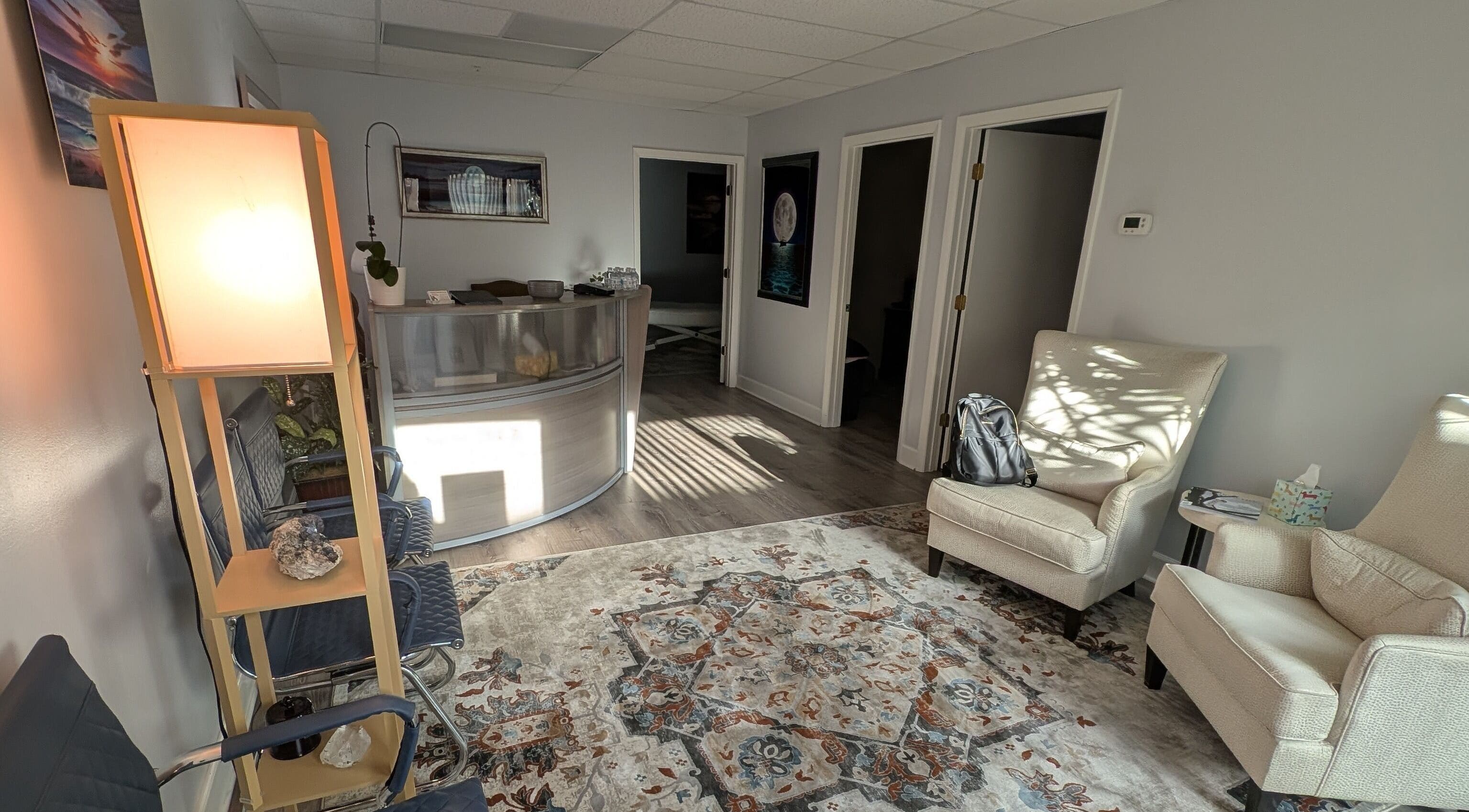 Inviting reception area of Naples Healing Arts in Naples, Florida, US, featuring comfortable seating and warm lighting.