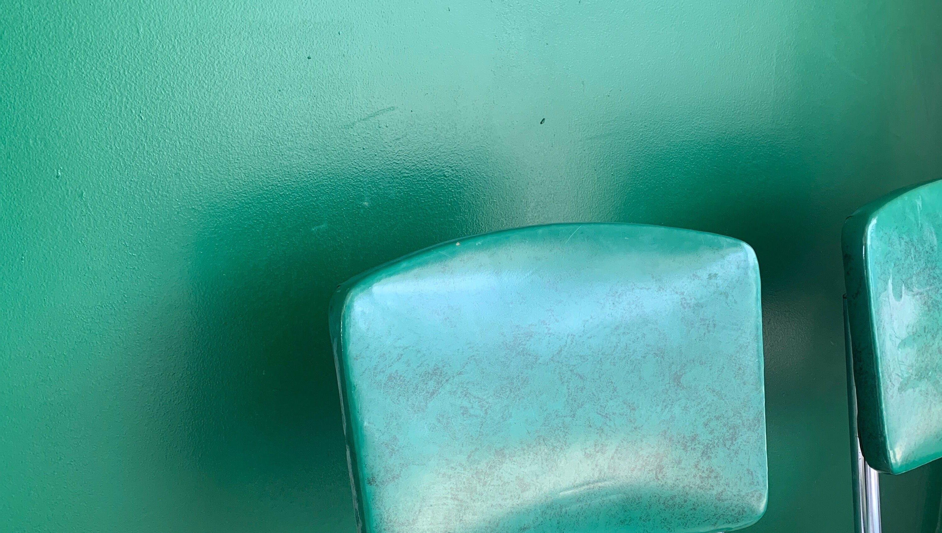 Green chairs at The Glow Up Room, Kenora, Ontario, CA, create a calming ambience for wellness treatments.