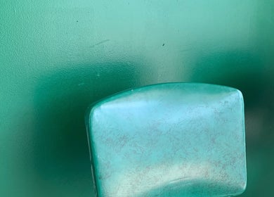 Green chairs at The Glow Up Room, Kenora, Ontario, CA, create a calming ambience for wellness treatments.
