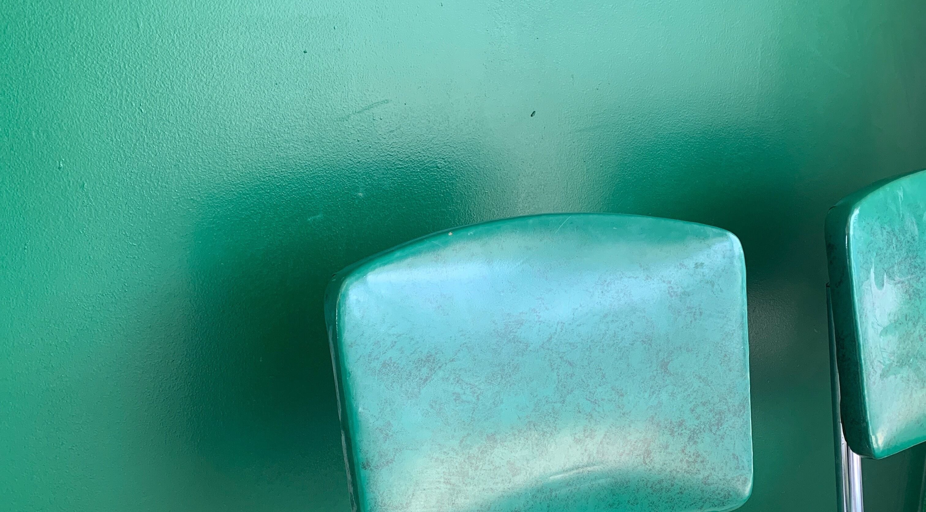 Green chairs at The Glow Up Room, Kenora, Ontario, CA, create a calming ambience for wellness treatments.