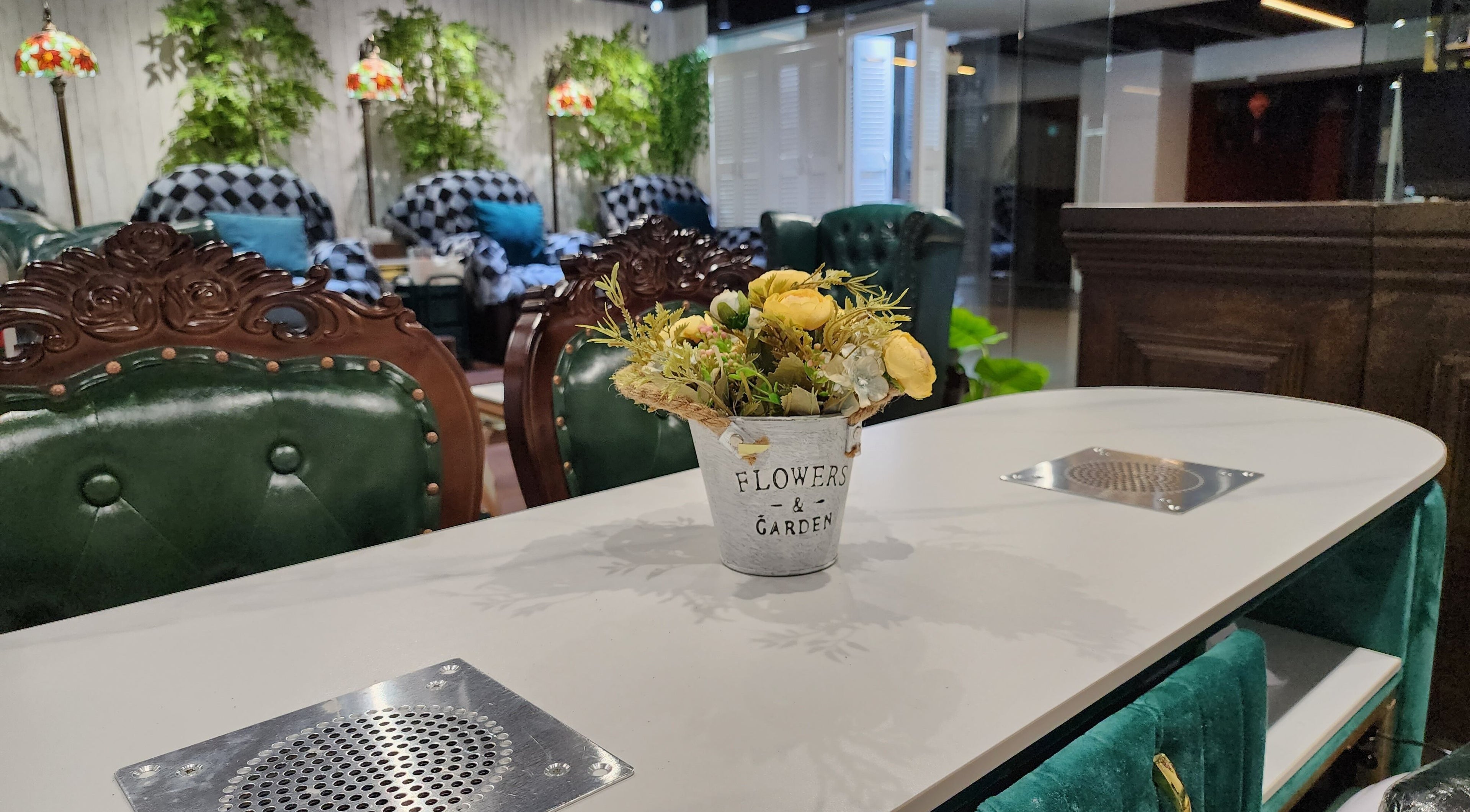 Elegant interior of Home Nails with plush chairs and flowers, Singapore, Singapore, SG.