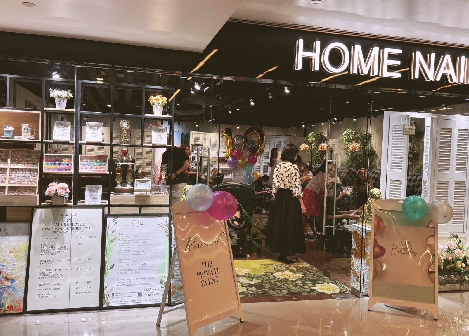 Home Nails entrance in Singapore, SG showcasing a chic interior and festive decor.