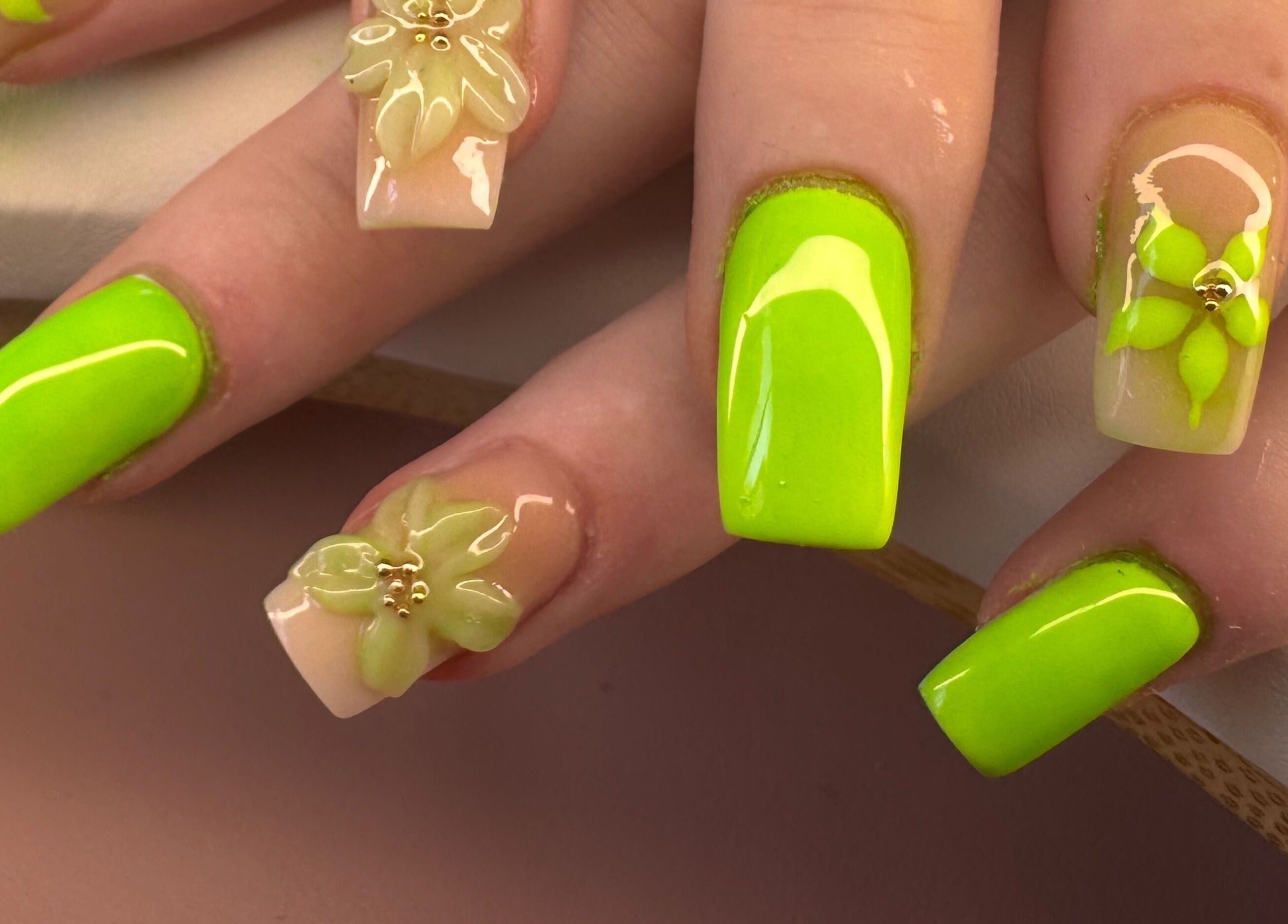 Neon green nails with floral designs by Diamond Nails by Mariela, Sindlesham, England, GB.
