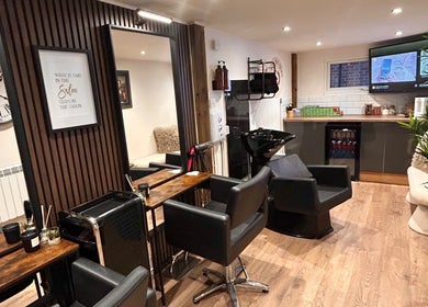Elegant interior of Hair By Jess salon at Penlle'r-gaer, Cymru, GB with sleek chairs and modern decor.