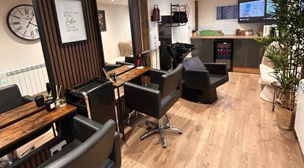 Elegant salon interior at Hair By Jess, Penllergaer, Cymru, GB, featuring stylish black chairs and modern decor.