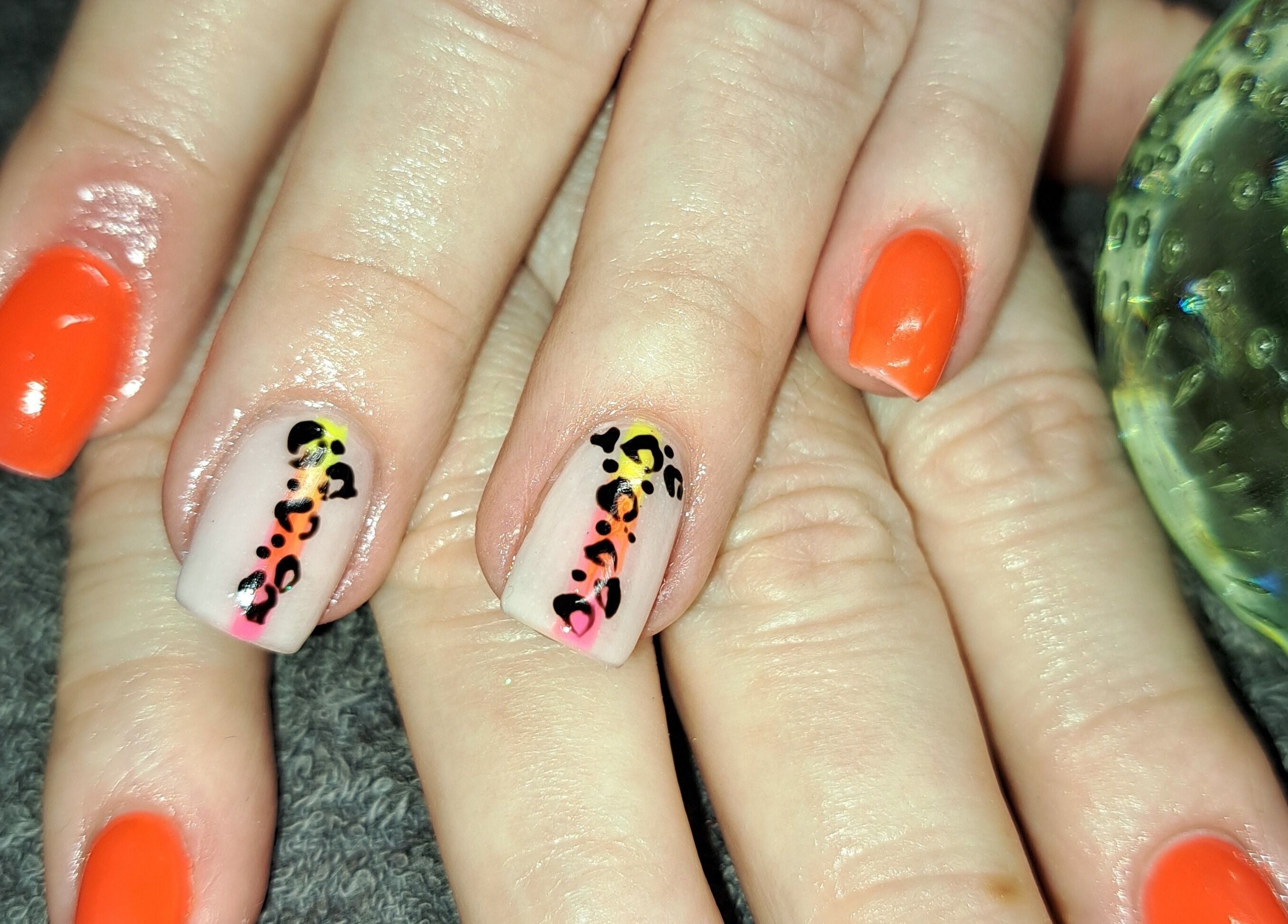 Bold nail art at Beauty and Hair with Flair, Pongola, Kwazulu-natal, ZA. Orange and leopard print designs.