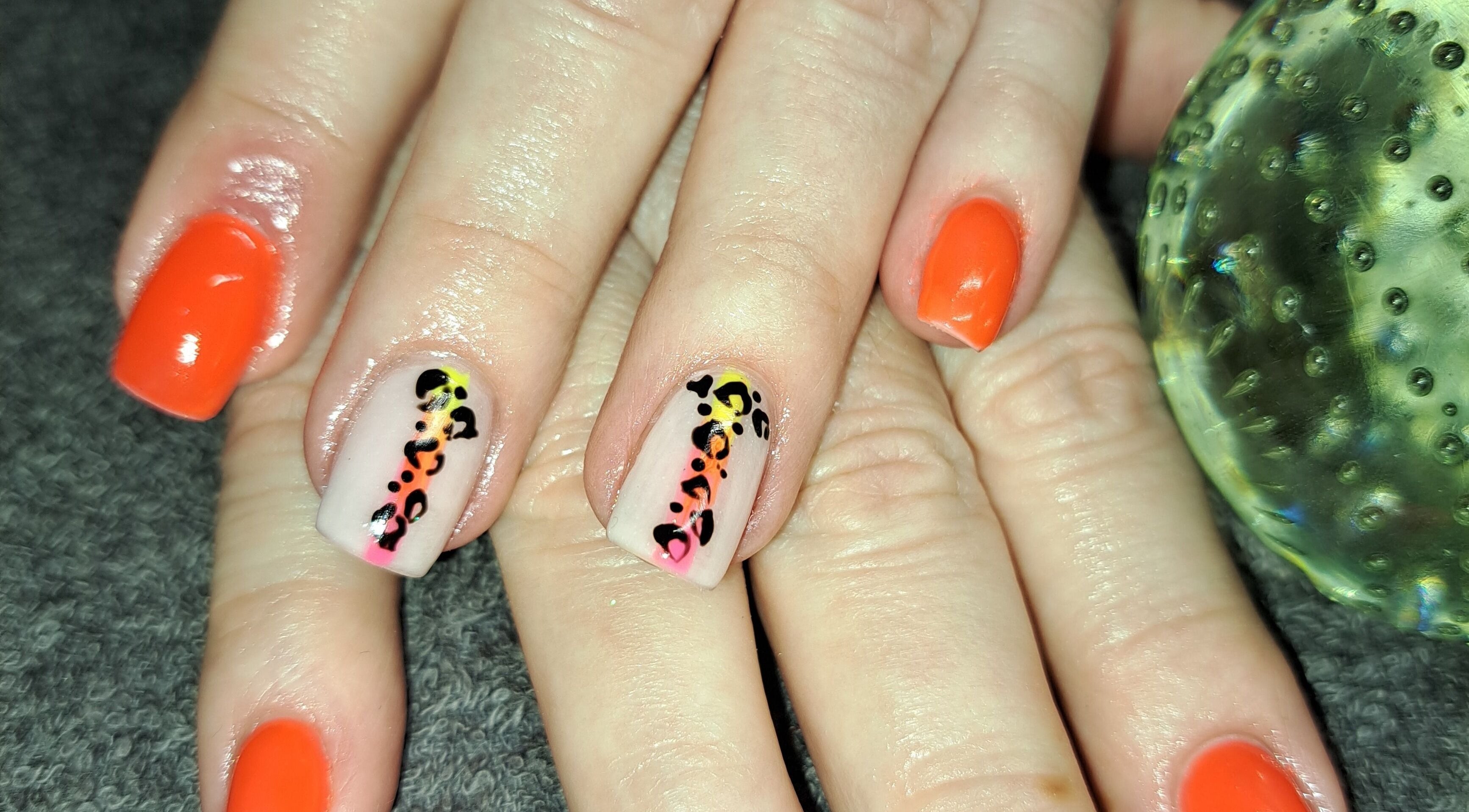 Bold nail art at Beauty and Hair with Flair, Pongola, Kwazulu-natal, ZA. Orange and leopard print designs.
