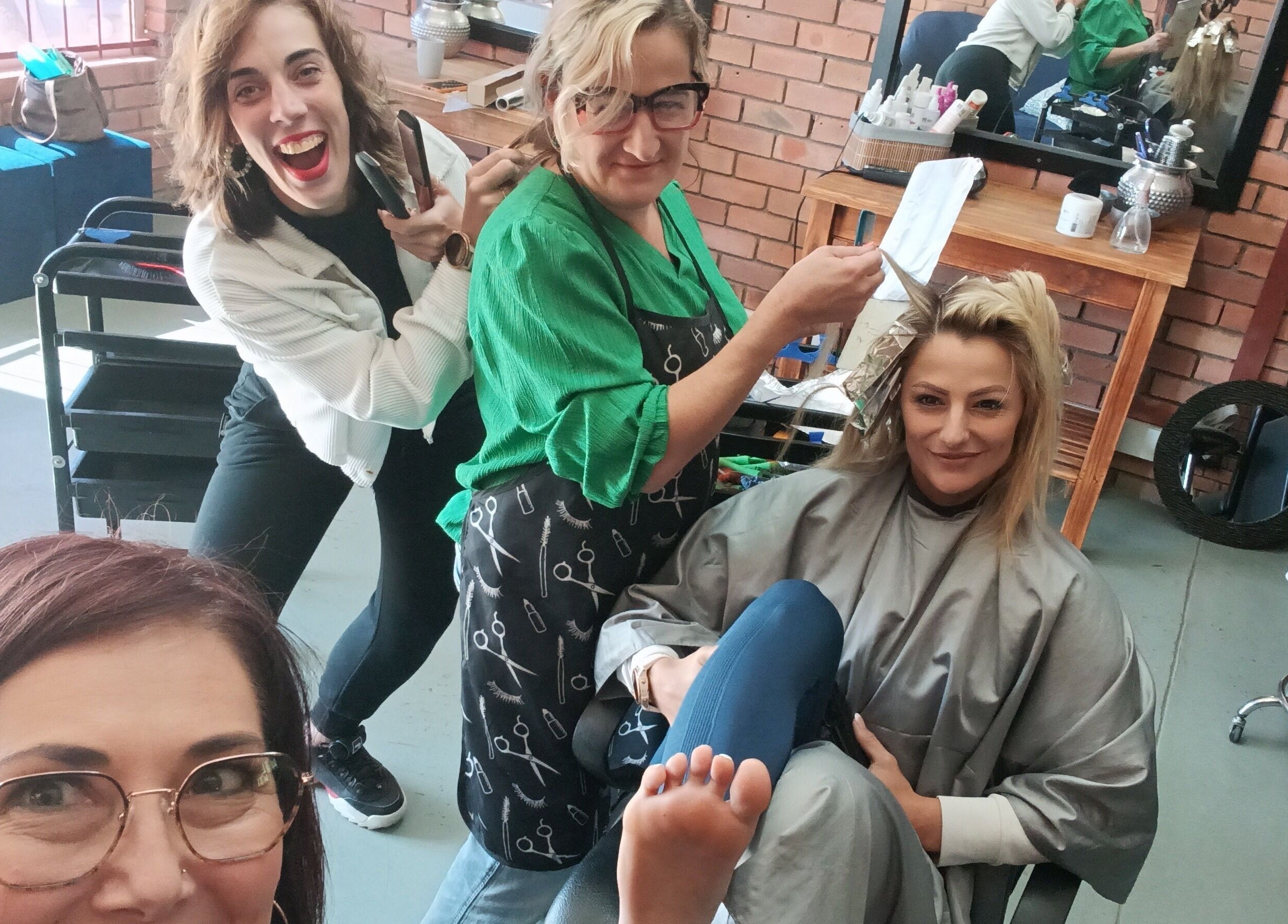 Stylists at Beauty and Hair with Flair, Pongola, Kwazulu-natal, ZA, create a fun atmosphere during a hair service.