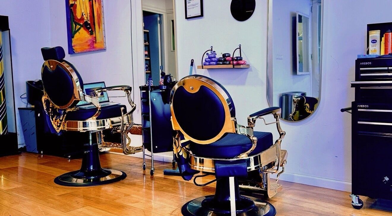 Elegant barber chairs at Tito barbershop, Amsterdam, Noord-Holland, NL, with modern decor.