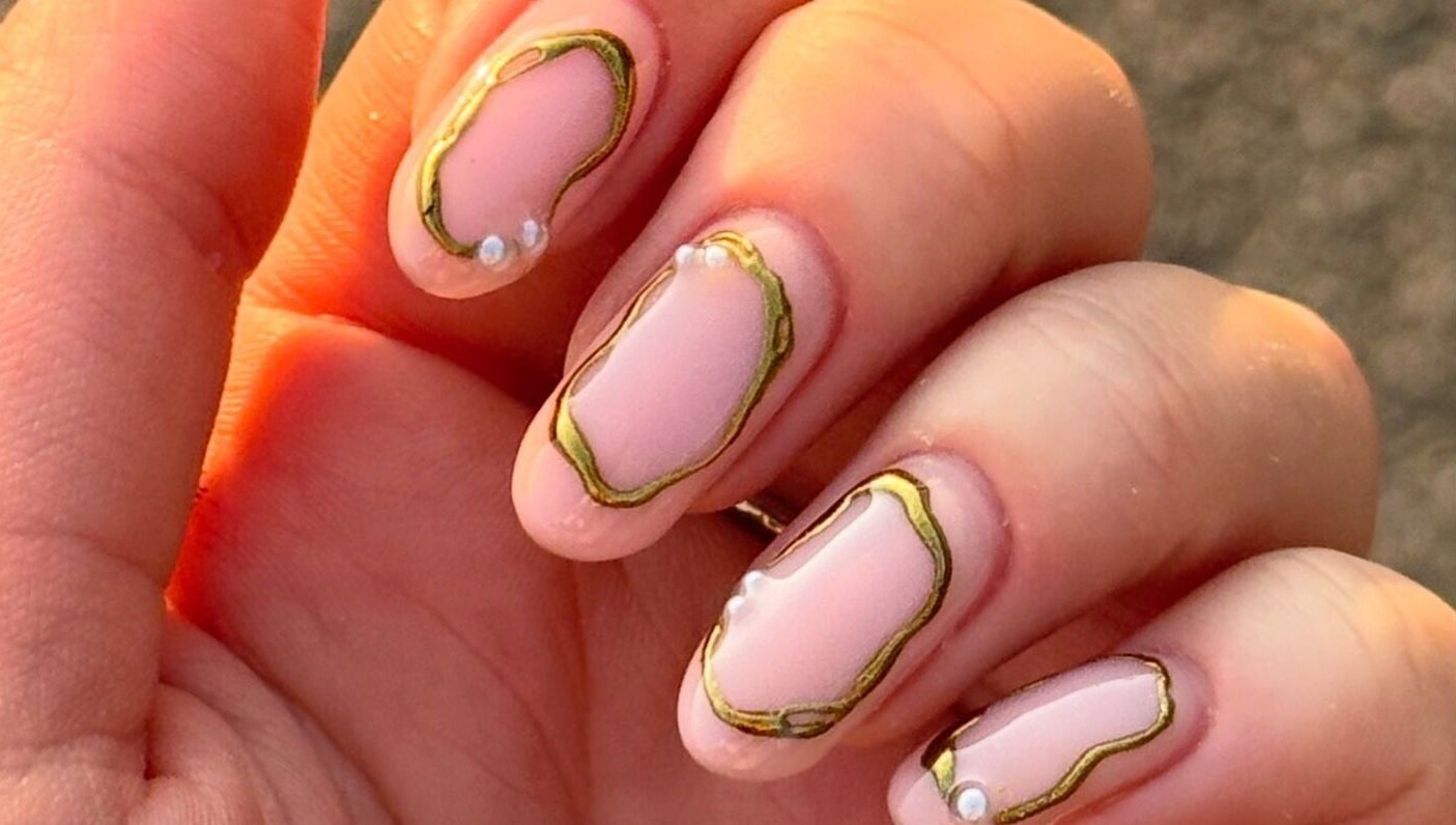 Stylish nail art with gold accents at ByAbi in Dinnington, England, GB.