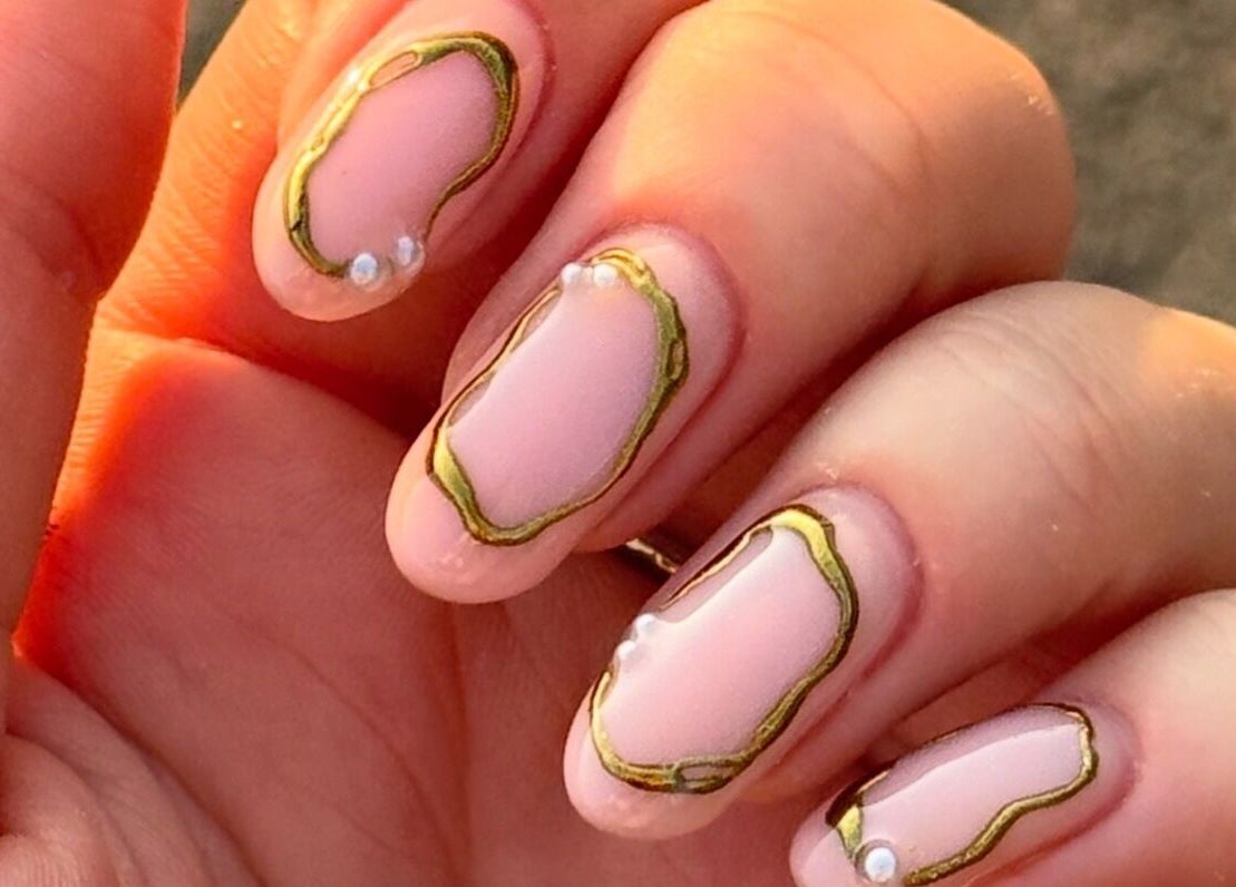 Stylish nail art with gold accents at ByAbi in Dinnington, England, GB.