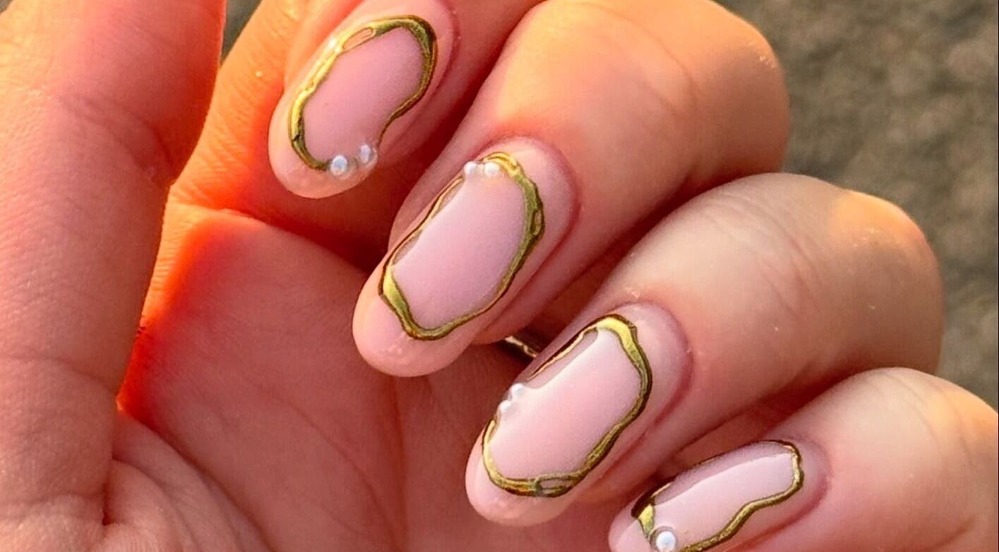 Stylish nail art with gold accents at ByAbi in Dinnington, England, GB.