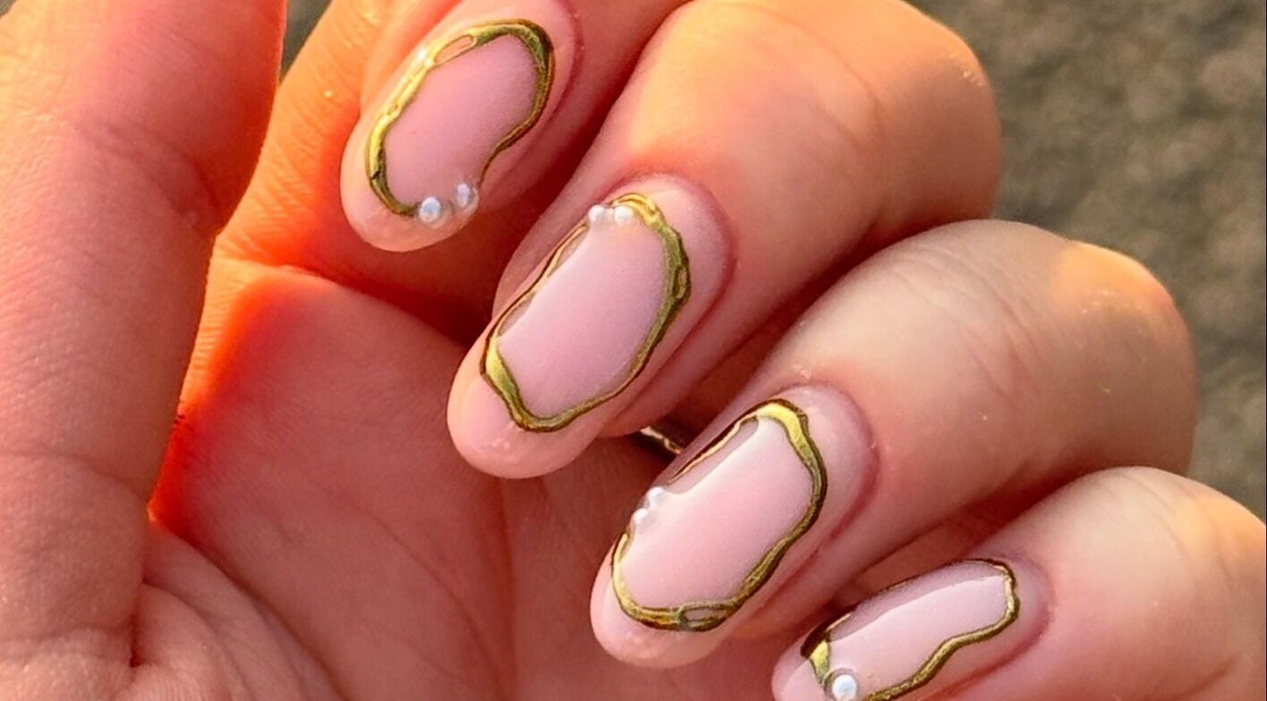 Stylish nail art with gold accents at ByAbi in Dinnington, England, GB.