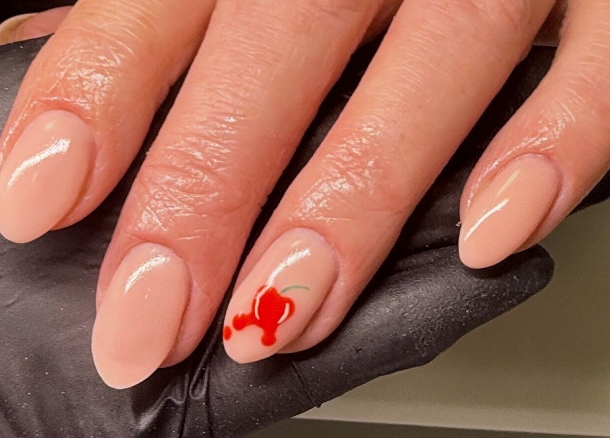 Elegant nude nails with a cherry design at ByAbi, Dinnington, England, GB.