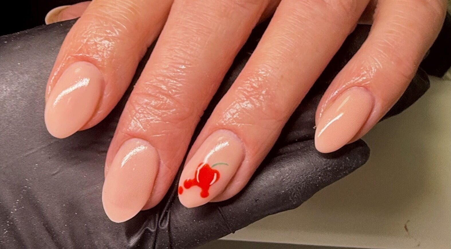 Elegant nude nails with a cherry design at ByAbi, Dinnington, England, GB.
