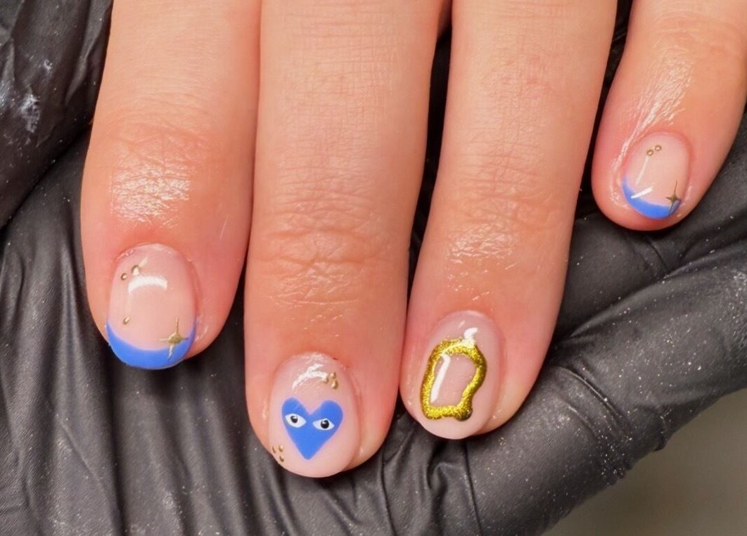 Decorative nail art with blue accents by ByAbi in Dinnington, England, GB, showcasing intricate designs.