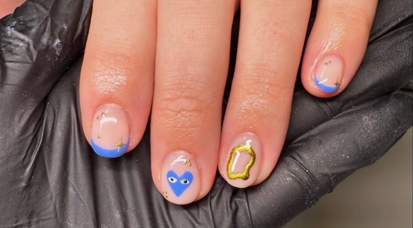 Decorative nail art with blue accents by ByAbi in Dinnington, England, GB, showcasing intricate designs.