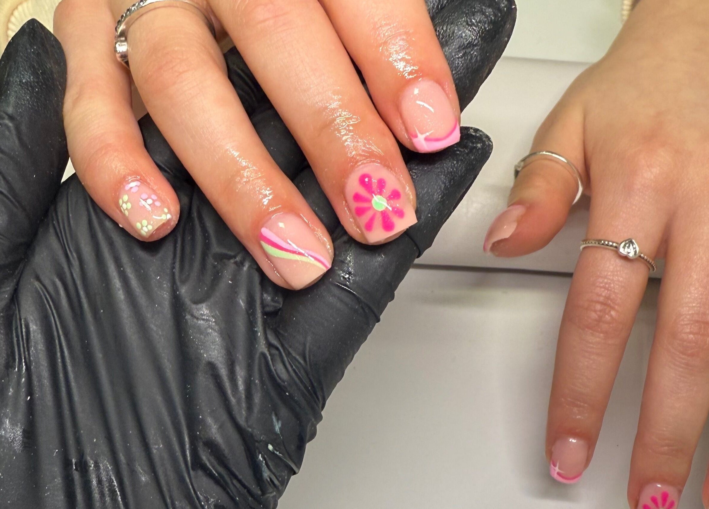 Vibrant floral nail art at ByAbi in Dinnington, England, GB, showcasing expert manicure skills.