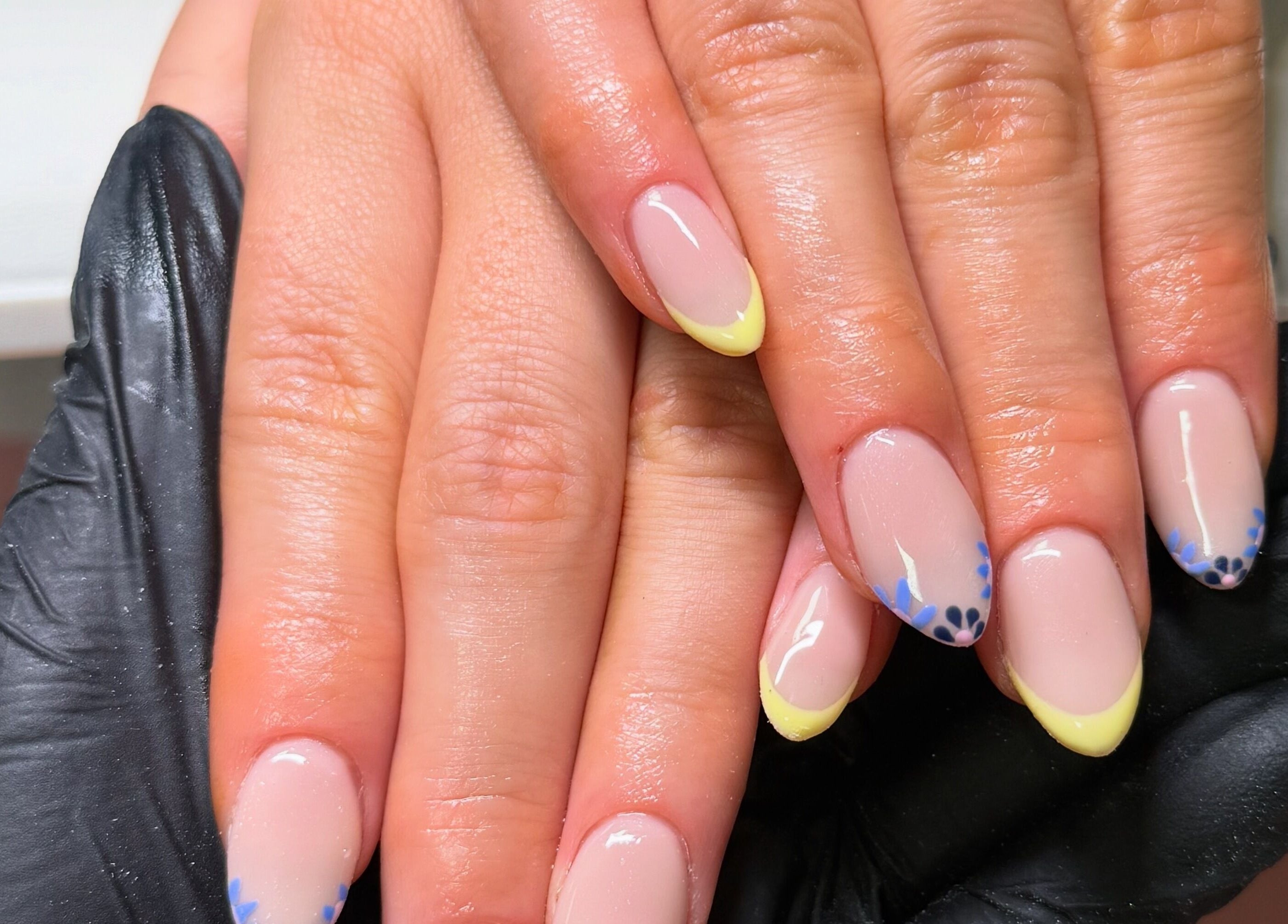 Stylish floral nail art at ByAbi in Dinnington, England, GB, showcasing intricate design and glossy finish.