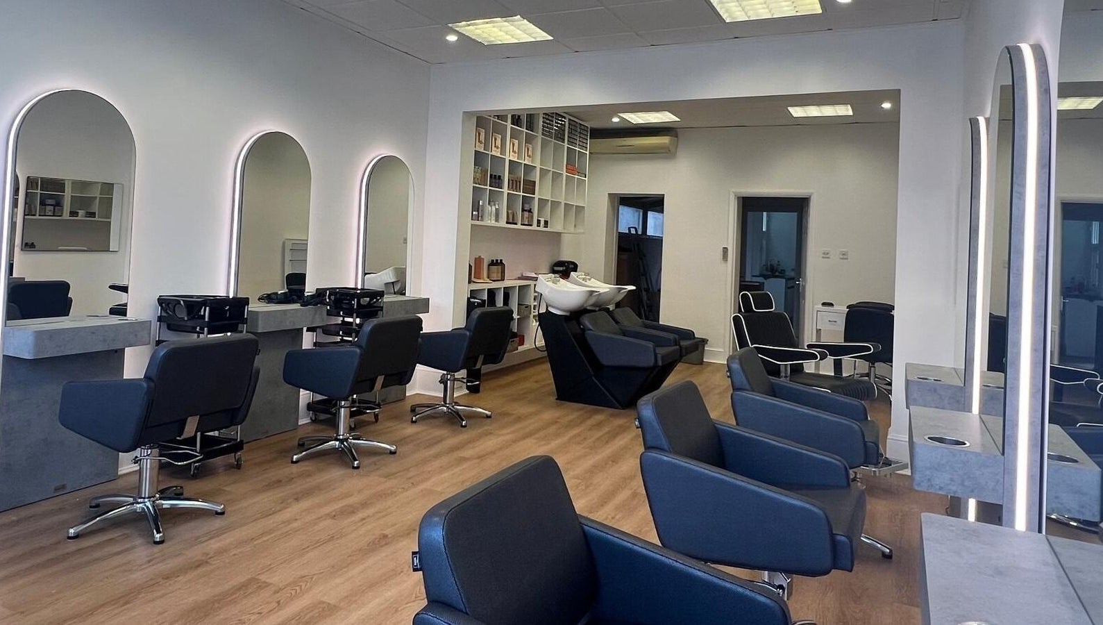 Modern salon interior with sleek chairs and mirrors at estezone, Tonbridge, England, GB.
