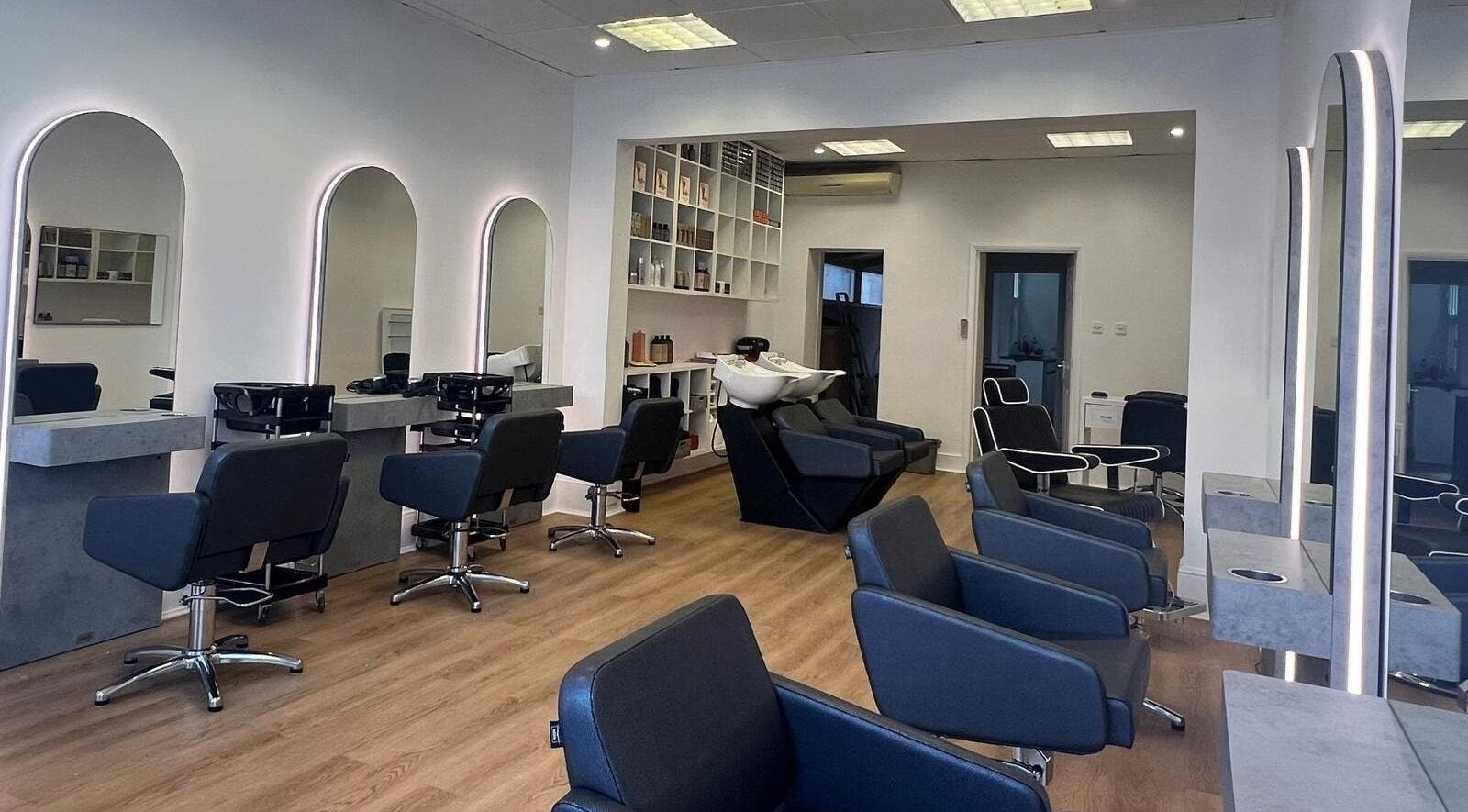 Modern salon interior with sleek chairs and mirrors at estezone, Tonbridge, England, GB.