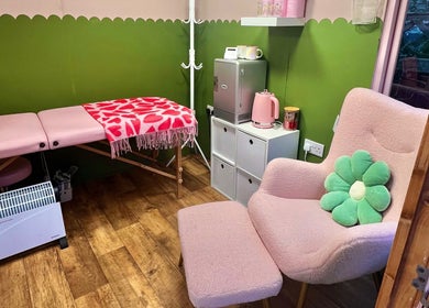 Chic treatment room at Daryl’s Beauty Room, Walmer, England features pink decor and inviting atmosphere.