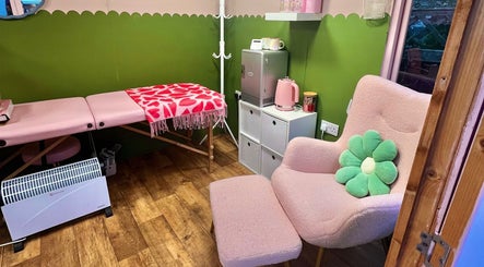 Chic treatment room at Daryl’s Beauty Room, Walmer, England features pink decor and inviting atmosphere.
