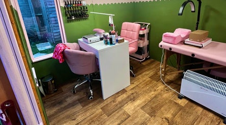 Cozy interior of Daryl’s Beauty Room in Walmer, England, featuring elegant pink chairs and nail care tools.