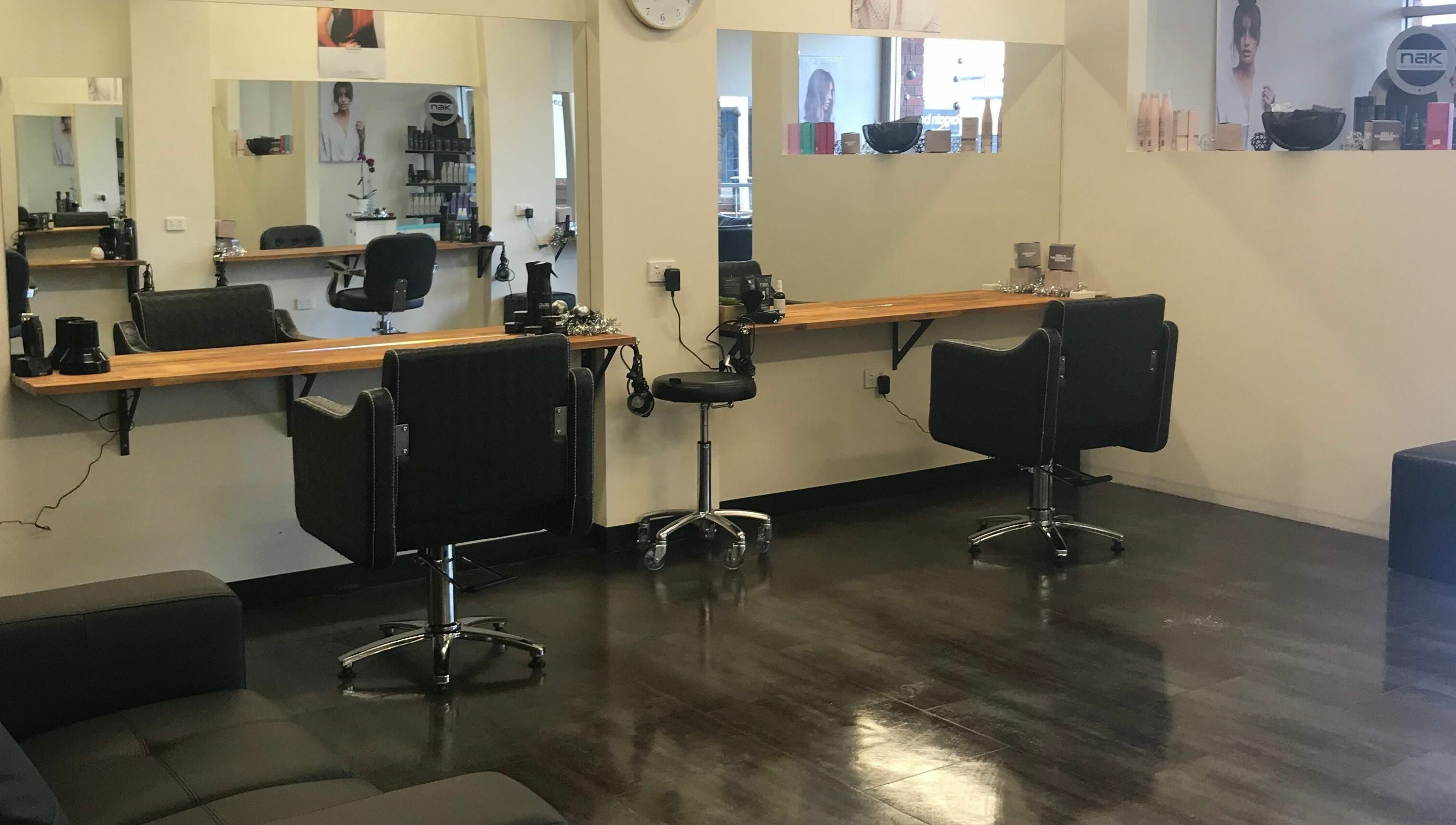 Modern salon interior at Teazed, Scottsdale, Tasmania, AU featuring sleek black styling stations and large mirrors.