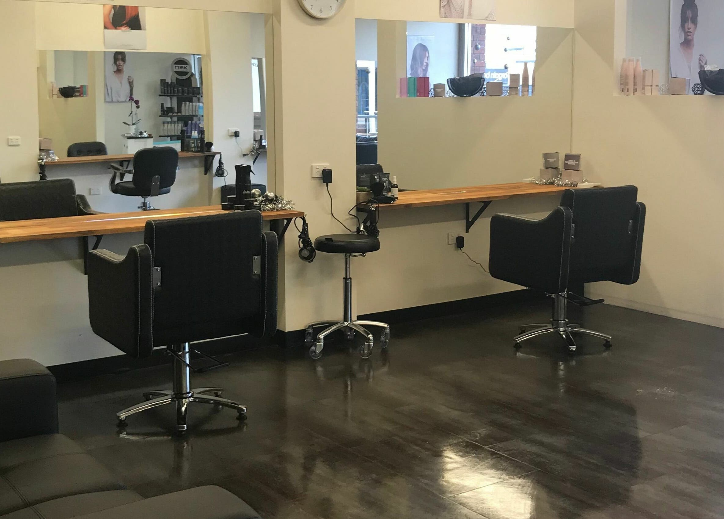 Modern salon interior at Teazed, Scottsdale, Tasmania, AU featuring sleek black styling stations and large mirrors.
