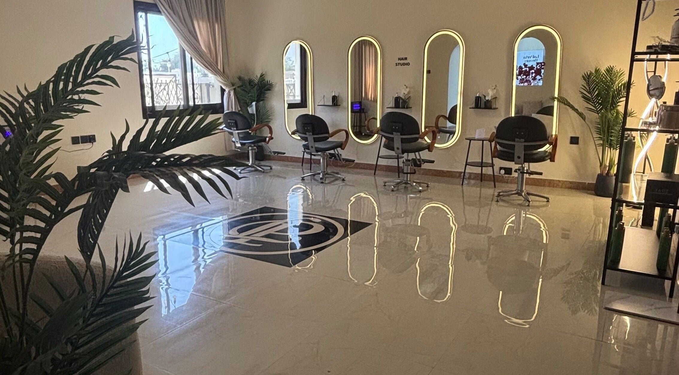 Sophisticated interior of La Perla Beauty Salon in Umm Al Quwain, AE with stylish, modern salon chairs and mirrors.