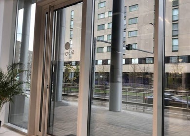 Bright entrance with large windows and a potted plant at Viktoria Sepp, Tallinn, Harju maakond, EE.