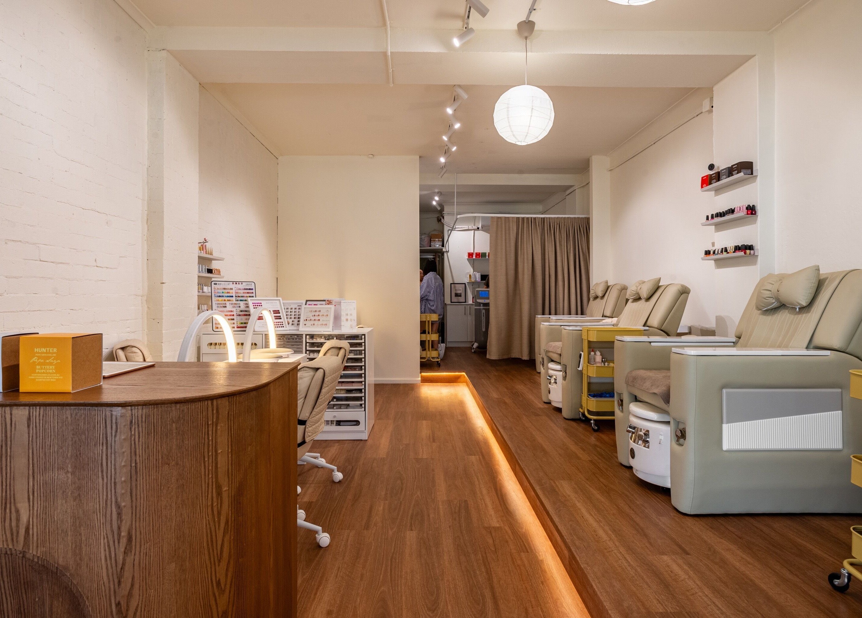 Spacious interior of Vaness Salon in Caringbah, New South Wales, AU, featuring elegant pedicure chairs and nail stations.