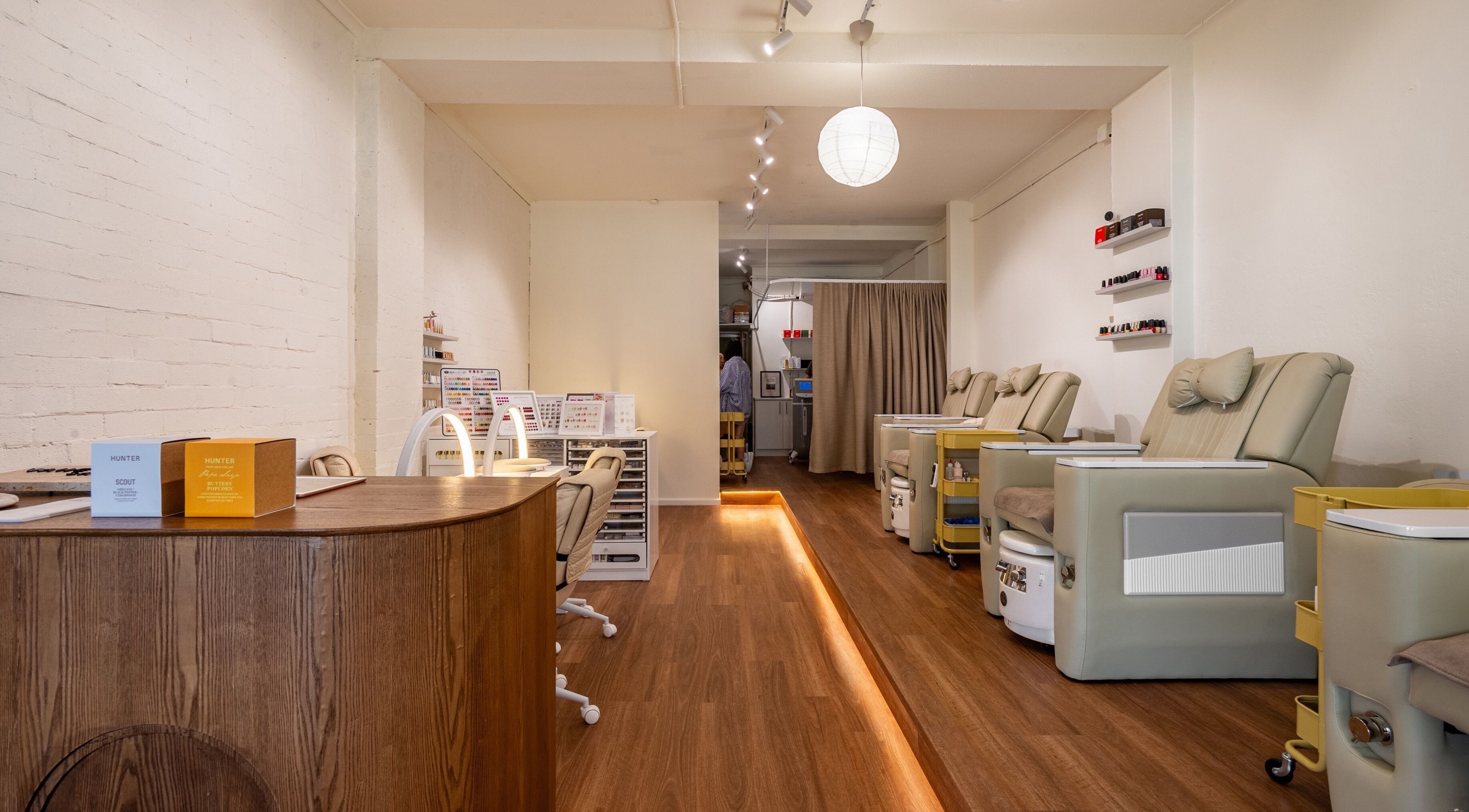 Spacious interior of Vaness Salon in Caringbah, New South Wales, AU, featuring elegant pedicure chairs and nail stations.