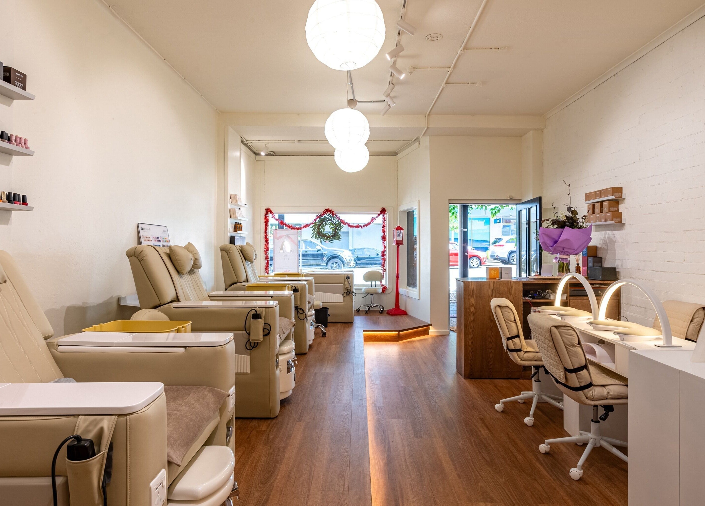 Stylish interior of Vaness Salon in Caringbah, New South Wales, AU, featuring modern chairs and nail stations.